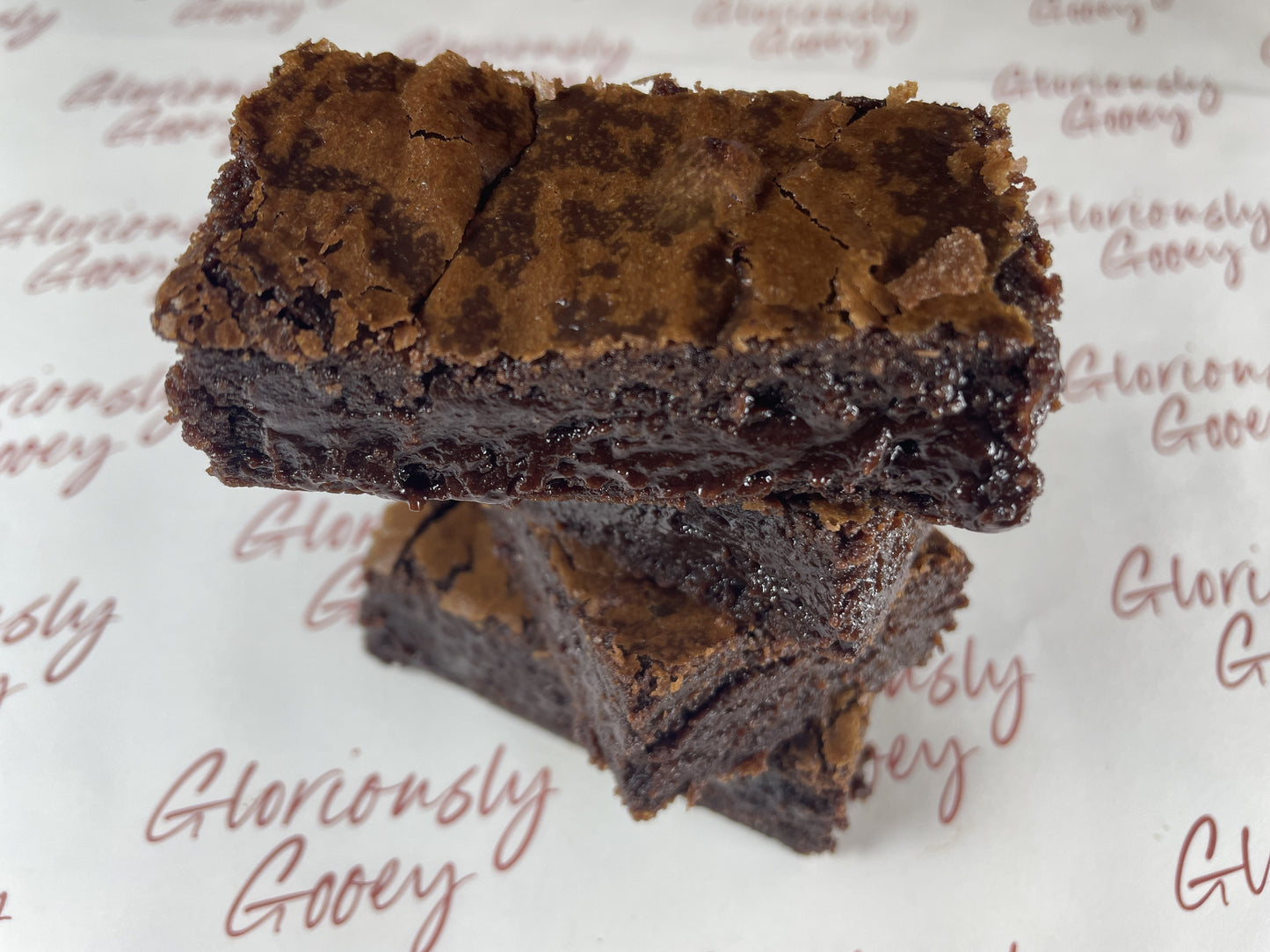 Stack of gloriously gooey brownies with a rich chocolate texture and a perfect balance of crisp and soft layers